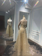 Mandotos luxury toast evening dress with a golden neck hanging light design, elegant for formal occasions.