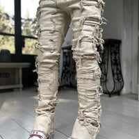 Men's stacked jeans by MANDOTOS featuring patched details, long tight fit trousers with bold style and modern denim design.