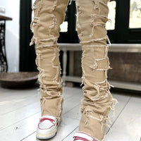 Men's stacked jeans by MANDOTOS with patched details, long tight fit trousers for a bold street style look.