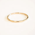14K gold filled textured stacking ring by MANDOTOS, showcasing a close-up view of its detailed, shiny surface and design.