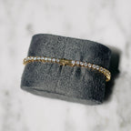18K gold-plated zircon tennis bracelet by MANDOTOS featuring sparkling cubic zirconia stones and a sleek, elegant design.