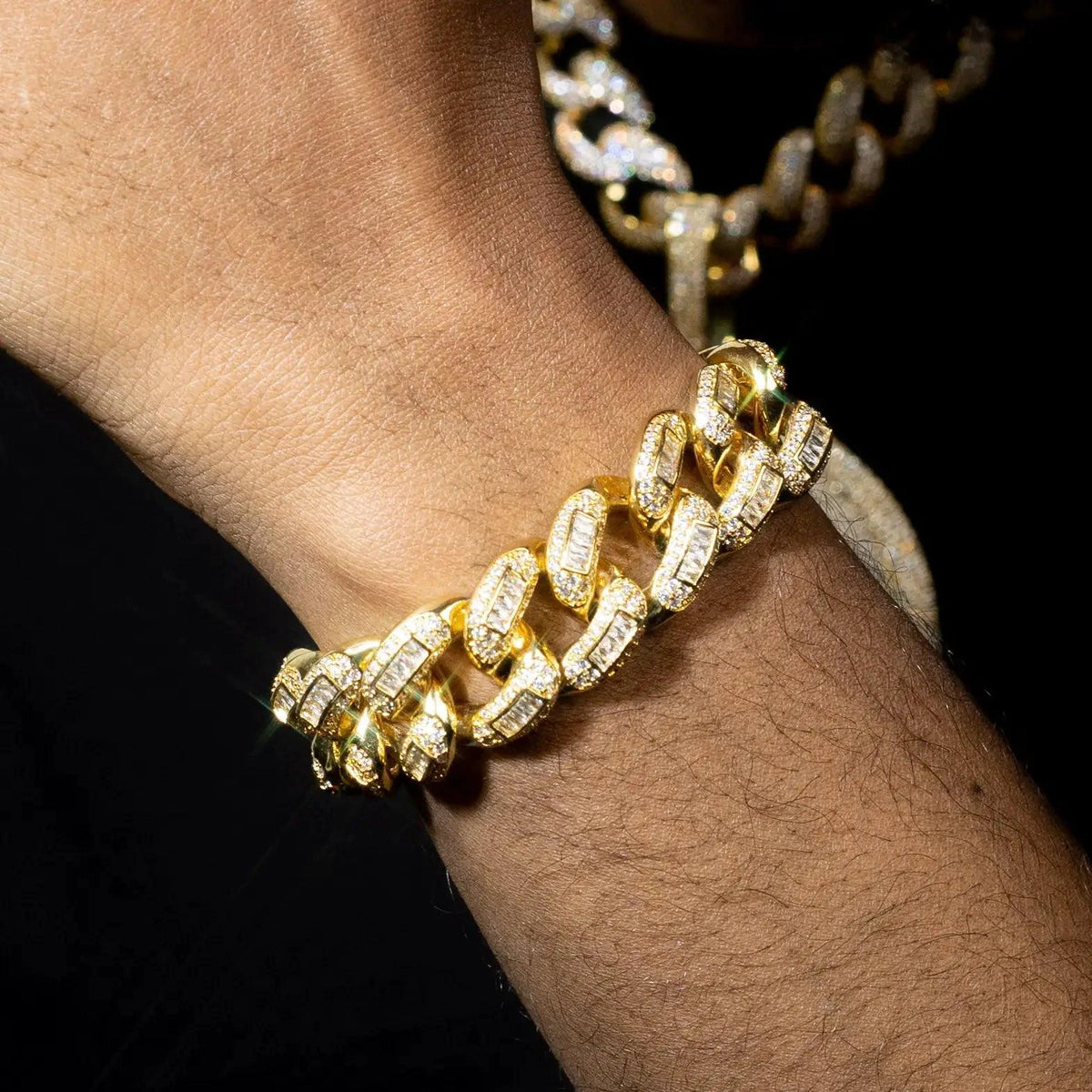 20mm luxury gold Cuban bracelet by MANDOTOS featuring thick, polished gold links on a sleek jewelry display.
