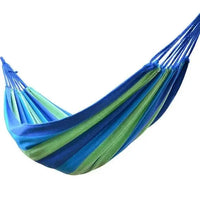 Mandotos adventure-ready hammock hanging between trees, lightweight and durable outdoor camping hammock for relaxing in nature