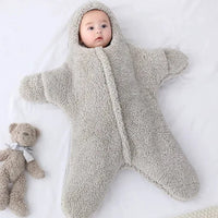Soft baby quilt by MANDOTOS with pastel colors and cozy fabric, perfect for nursery and stroller comfort.