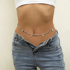 Mandotos Boho Glam Belly Chain featuring layered gold-tone designs with beads and charms on a model's midriff.