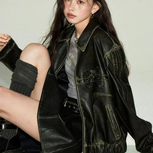 Mandotos Bow Biker's Leather Jacket featuring a sleek black design and stylish bow detail for a bold, edgy look.