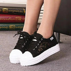 Mandotos women's canvas shoes featuring a casual, stylish design with white laces and a comfortable flat sole.