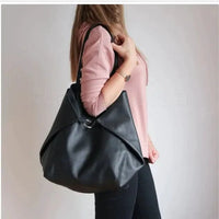Mandotos chic leather tote handbag with sturdy handles and sleek design, perfect for everyday use.