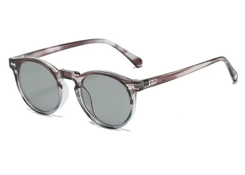Mandotos chic round UV-block sunglasses with dark tinted lenses and thin metal frames on a white background.