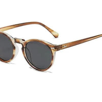 Mandotos chic round UV-block sunglasses with black frames and tinted lenses, stylish and protective eyewear.