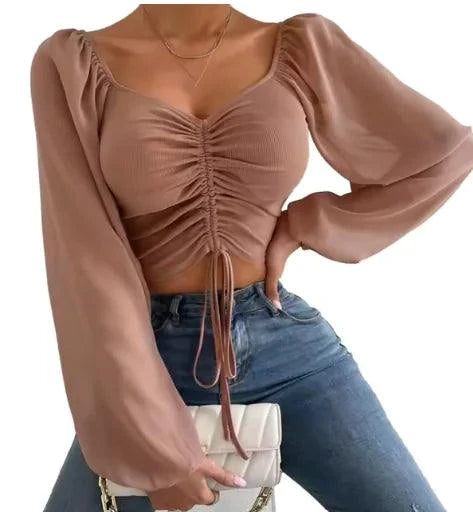 Mandotos chic V-neck balloon sleeve crop top displayed on a model, featuring stylish design and trendy silhouette.