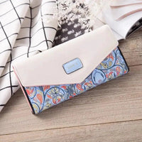 Elegant black leather women's clutch wallet and card holder by MANDOTOS with sleek design and multiple card slots.