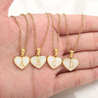 Mandotos 26-letter heart-shaped necklace with white shell love pendant on a delicate clavicle chain for women’s jewelry.