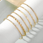 Mandotos bohemian metal chain bracelet set for women featuring six gold-colored geometric thick link bangles.