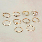 Mandotos Bohemian star, moon, pearl, and leaf rings in a 10-piece gold-finish stackable ring set, featuring intricate designs.