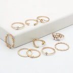 Mandotos 10-piece bohemian ring set with star, moon, pearl, and leaf designs in gold finish, stackable and stylish jewelry.
