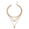 Mandotos chunky gold layered necklace with coin pendant and sun charm, designed for women, featuring bold, stylish jewelry.