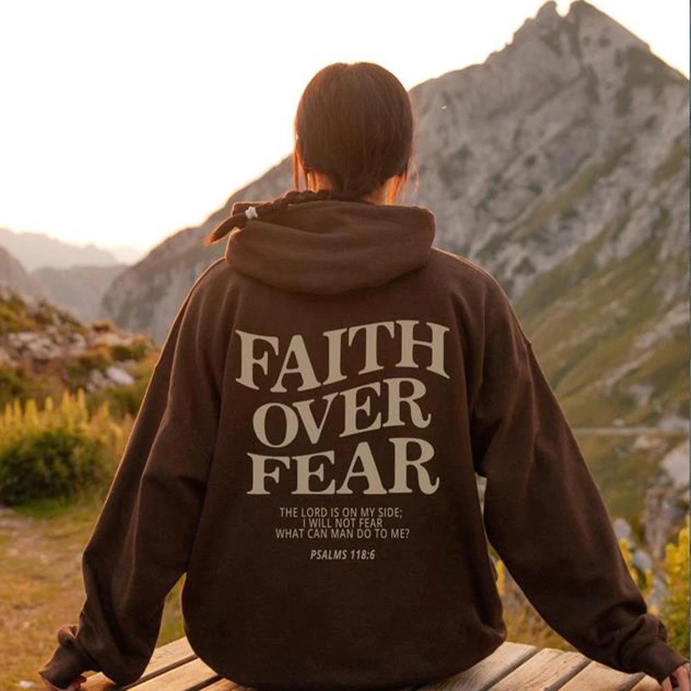 Unisex brown Christian hoodie by Mandotos featuring Psalm 118:6 "Faith Over Fear" text, casual fit with Bible verse design.