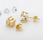 Elegant 18K gold and silver moissanite stud earrings by MANDOTOS, showcasing sparkling gemstones on a classic stud setting.