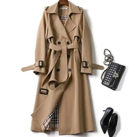 Mandotos elegant classic trench coat displayed on a hanger, showcasing its timeless design and neutral color.