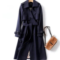 Mandotos elegant classic trench coat displayed on a hanger, showcasing its timeless design and tailored fit.