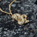 Elegant gold zircon dragon pendant by MANDOTOS featuring detailed dragon design and sparkling zircon stones.