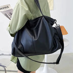 Elegant leather carryall bag by MANDOTOS, featuring a stylish design with sturdy handles and a spacious interior.