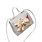 Elegant leather handbag and matching scarf from MANDOTOS, featuring stylish design and high-quality materials.