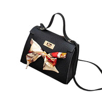 Elegant leather handbag and matching scarf by MANDOTOS, featuring stylish design and high-quality materials.