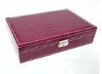 Elegant leather vanity case by MANDOTOS with a structured design and brass hardware, ideal for storing beauty essentials.