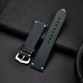 Elegant leather watch band by MANDOTOS, showing a close-up of the sleek, brown strap with stitching detail and polished metal buckle.