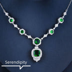Mandotos Emerald Elegance white gold necklace featuring a central emerald gemstone and delicate chain for sophisticated style.