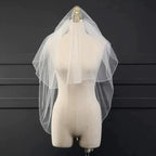 Ethereal double-tiered veil by MANDOTOS featuring delicate lace and airy tulle for a soft, romantic bridal look.