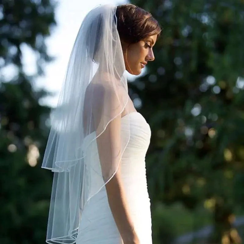 Elegant Ethereal Double Tiered Veil by MANDOTOS, lightweight tulle with layered design for bridal or formal wear.