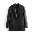 Mandotos Farah faux leather blazer displayed on a hanger, featuring a tailored fit and sleek black finish.