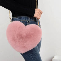 Mandotos women's heart-shaped faux fur crossbody handbag with plush fabric, chain strap, and soft shoulder design.