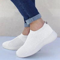 Mandotos flat knitted shoes in beige with slip-on design, showcasing their comfortable and stylish footwear look.