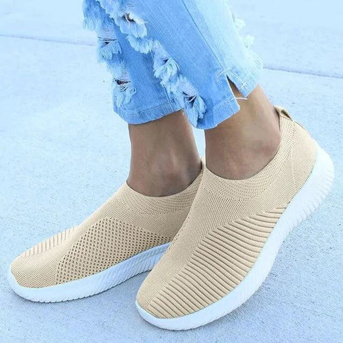 Mandotos flat knitted shoes in neutral tones, showcasing their comfortable, stylish design with detailed knit pattern.