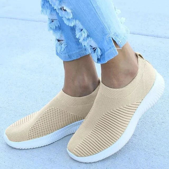 Mandotos flat knitted shoes in neutral color, showcasing their soft, flexible fabric and casual slip-on design.