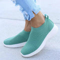 Mandotos flat knitted shoes in beige with white soles, showcasing a comfortable slip-on design and textured knit upper.