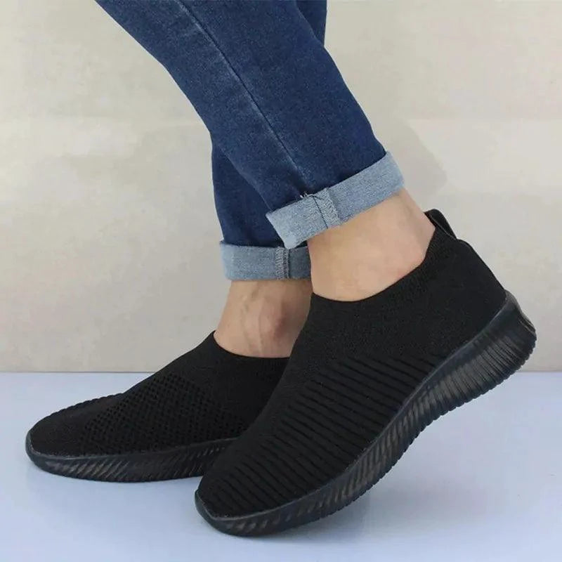 Mandotos flat knitted shoes featuring a comfortable, stylish design with a soft, woven upper and slip-on style.