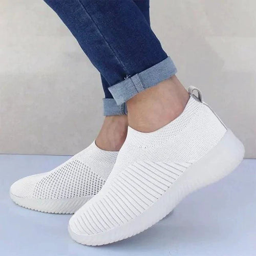 Mandotos flat knitted shoes in neutral tones, showcasing their comfortable, stylish design with a close-up view of the fabric and sole.