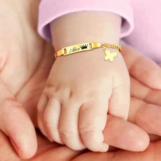 Gold butterfly charm bracelet for kids by MANDOTOS, featuring delicate butterfly charms and a secure clasp.