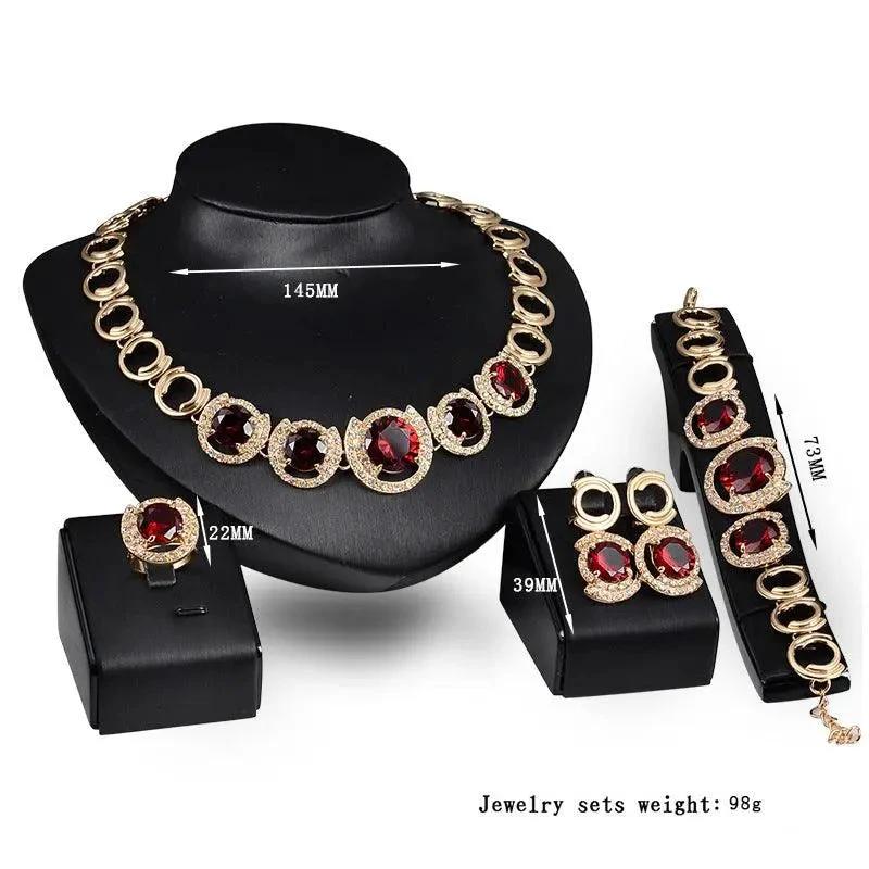 Mandotos gold jewelry set with four pieces featuring blue gems, perfect for wedding or special occasions.