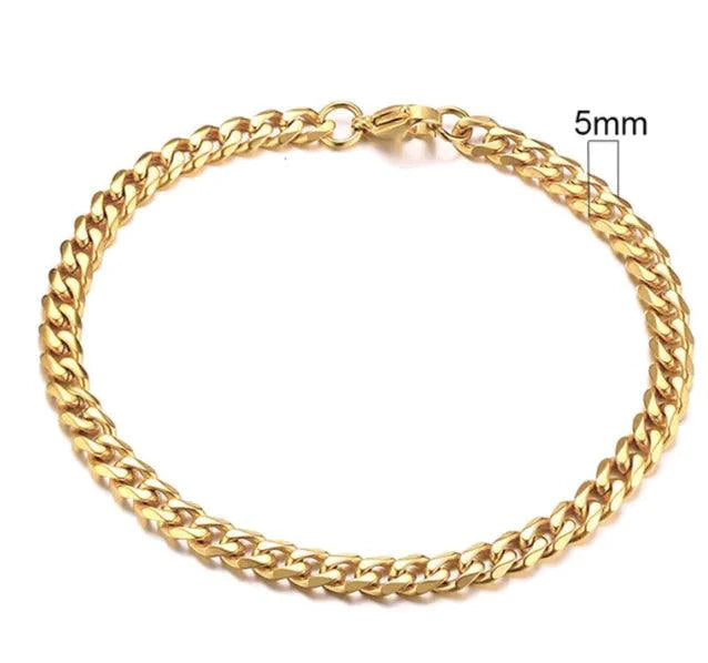 Gold-tone stainless steel Cuban bracelet by MANDOTOS featuring 3-11mm wide links, shown close-up on a neutral background.