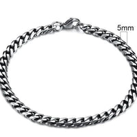Gold-tone stainless steel Cuban bracelet by MANDOTOS, 3-11mm wide, featuring classic interlocking links on a sleek design.