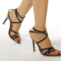 Golden strappy stiletto pumps by MANDOTOS with slender heel and elegant design, perfect for stylish evening wear.