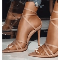 Golden strappy stiletto pumps by MANDOTOS with slender heel and elegant design, shown on a white background.