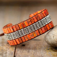 Handmade triple-layer natural stone bracelet by MANDOTOS showing various colorful stones and adjustable cord design.