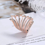 Mandotos Heavenly Diamond Wing Ring with sparkling diamonds and intricate wing design in sterling silver or white gold.